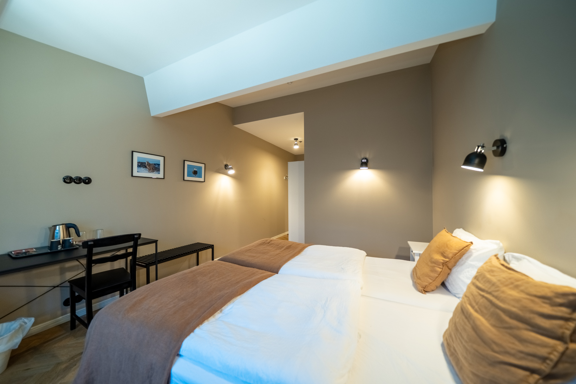 Economy room with desk and warm sconce lighting