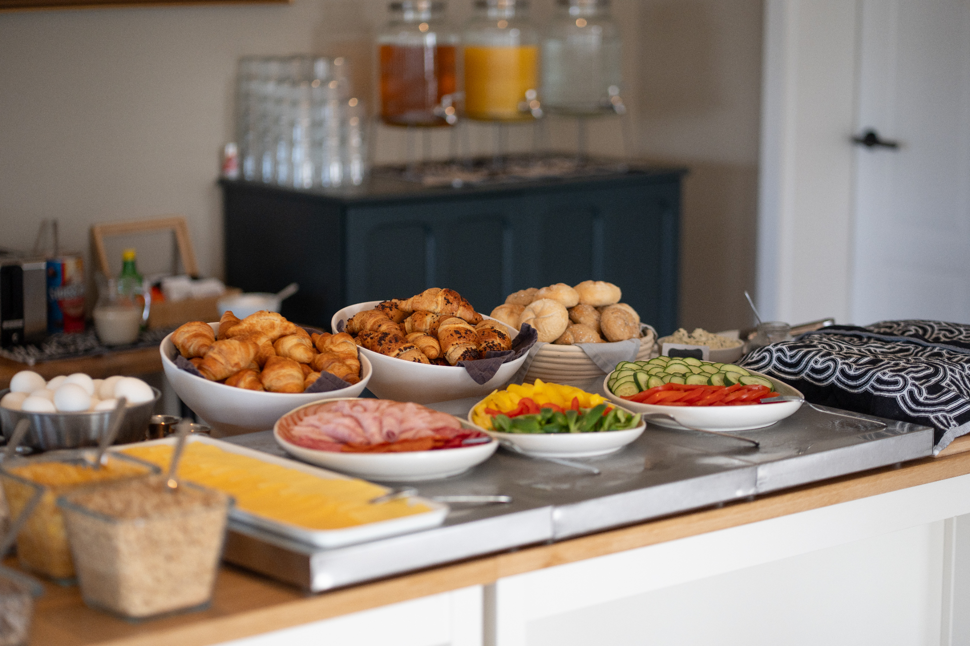 Breakfast buffet with cheeses, cold cuts, breads and jams