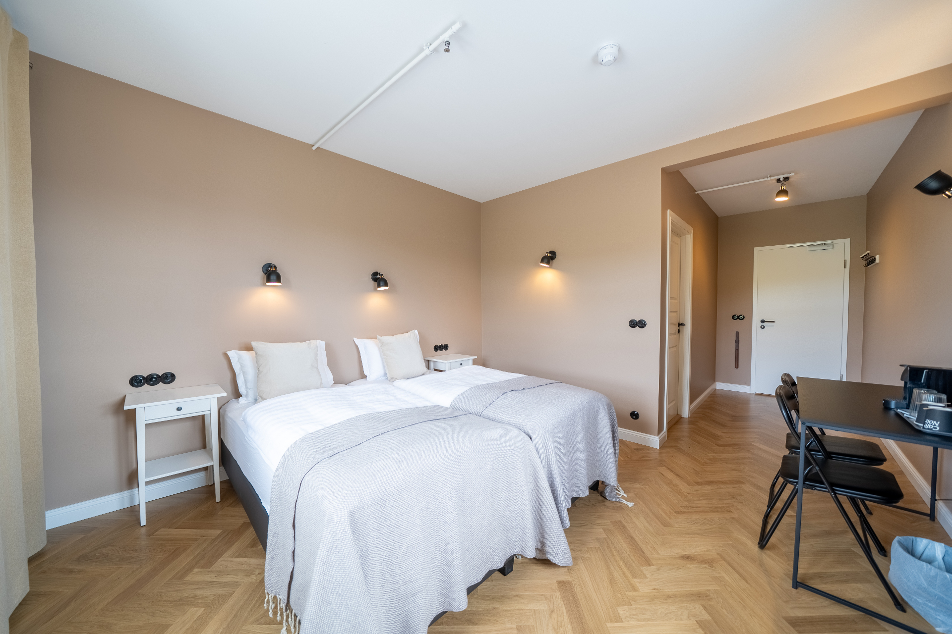 Twin beds with soft curtains and countryside view