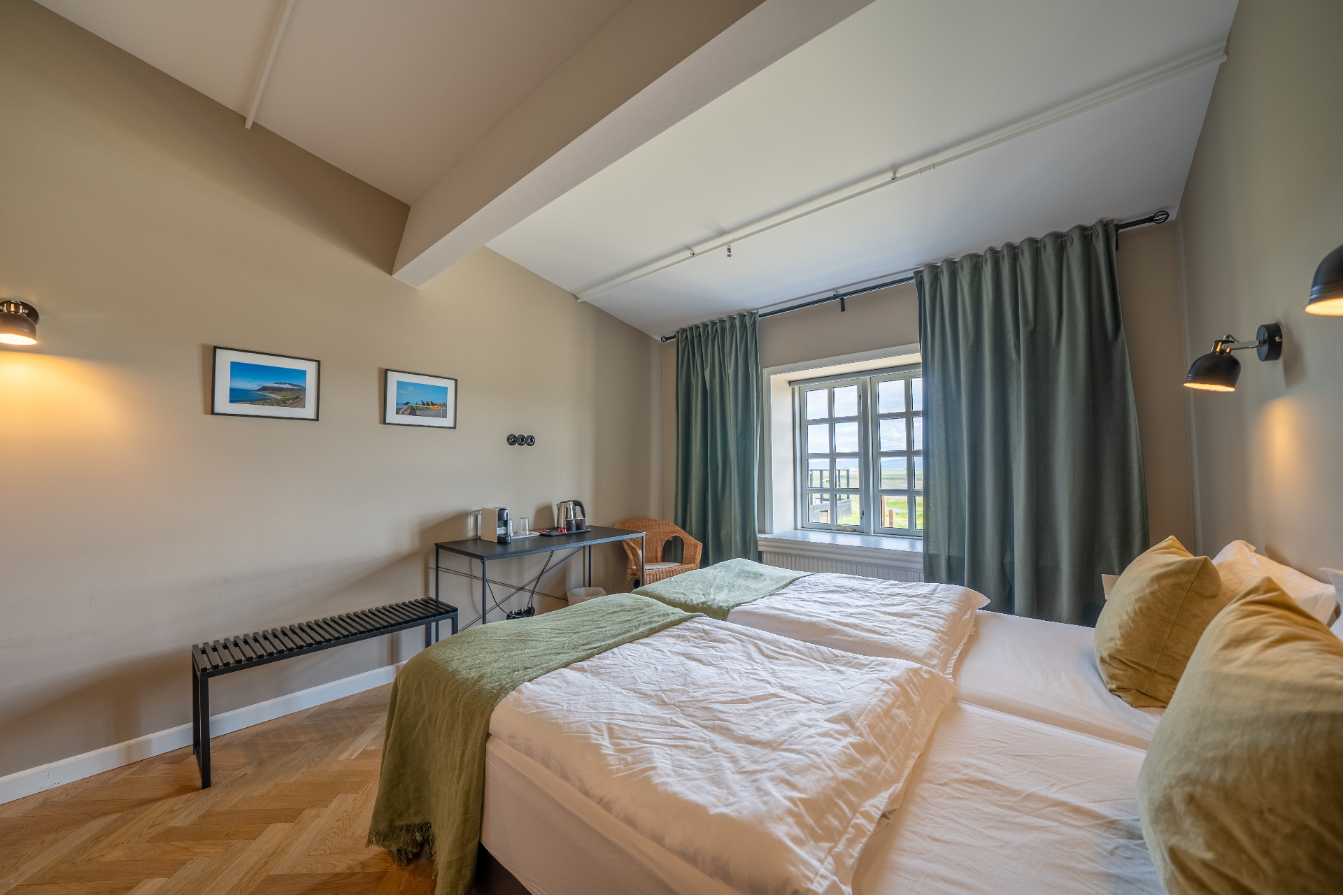 Superior twin beds with green throws and bedside lamps