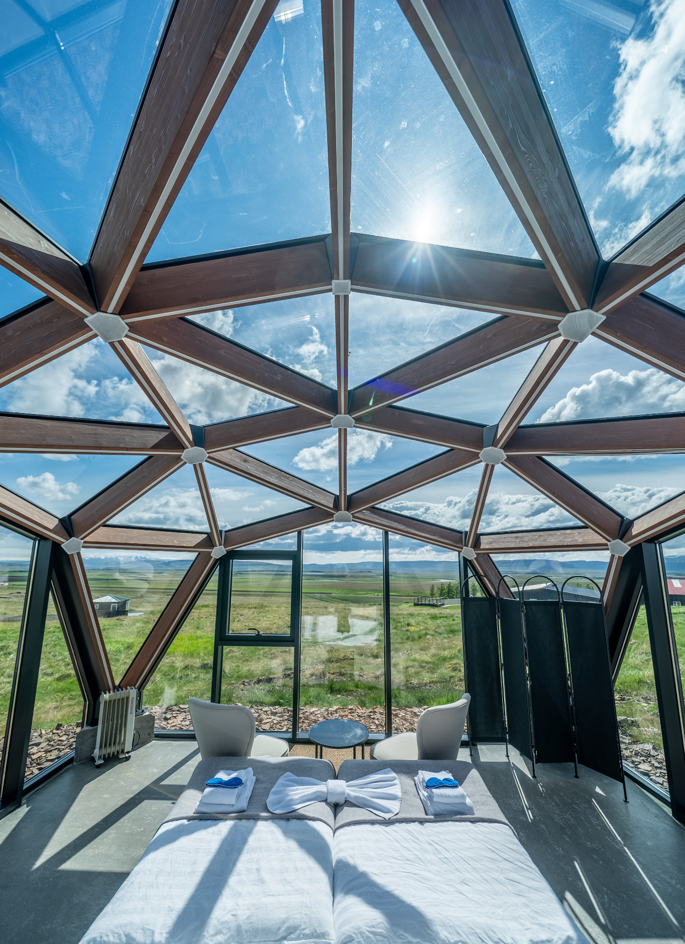 Glass dome ceiling of the Aurora Cabin open to the Icelandic sky