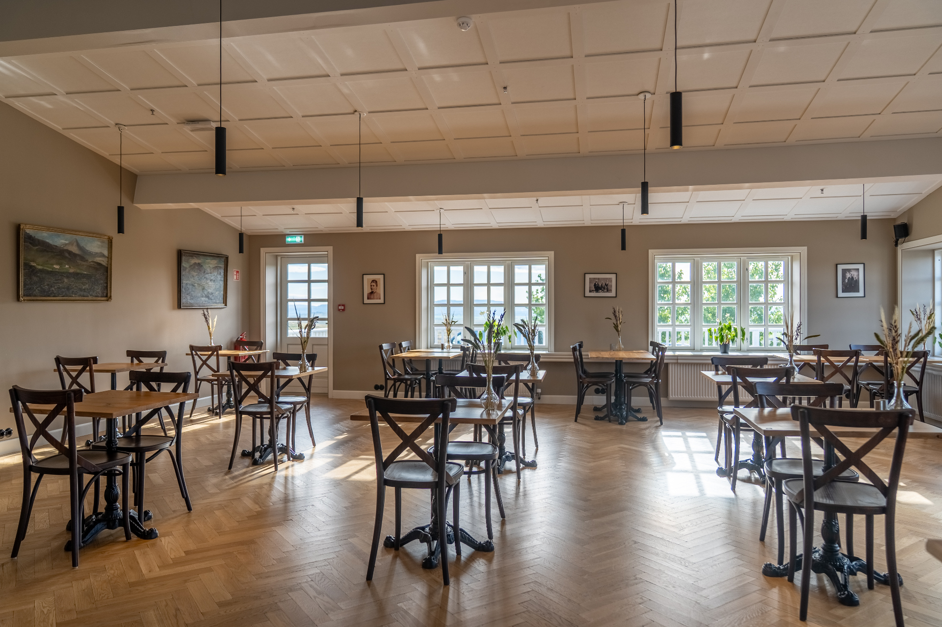 Light-filled restaurant dining room with herringbone floors