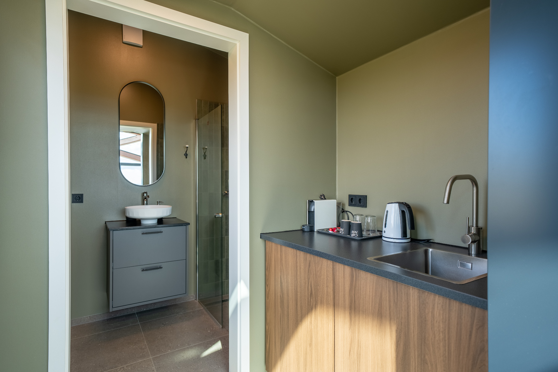 Kitchenette and bathroom entrance inside the Aurora Cabin